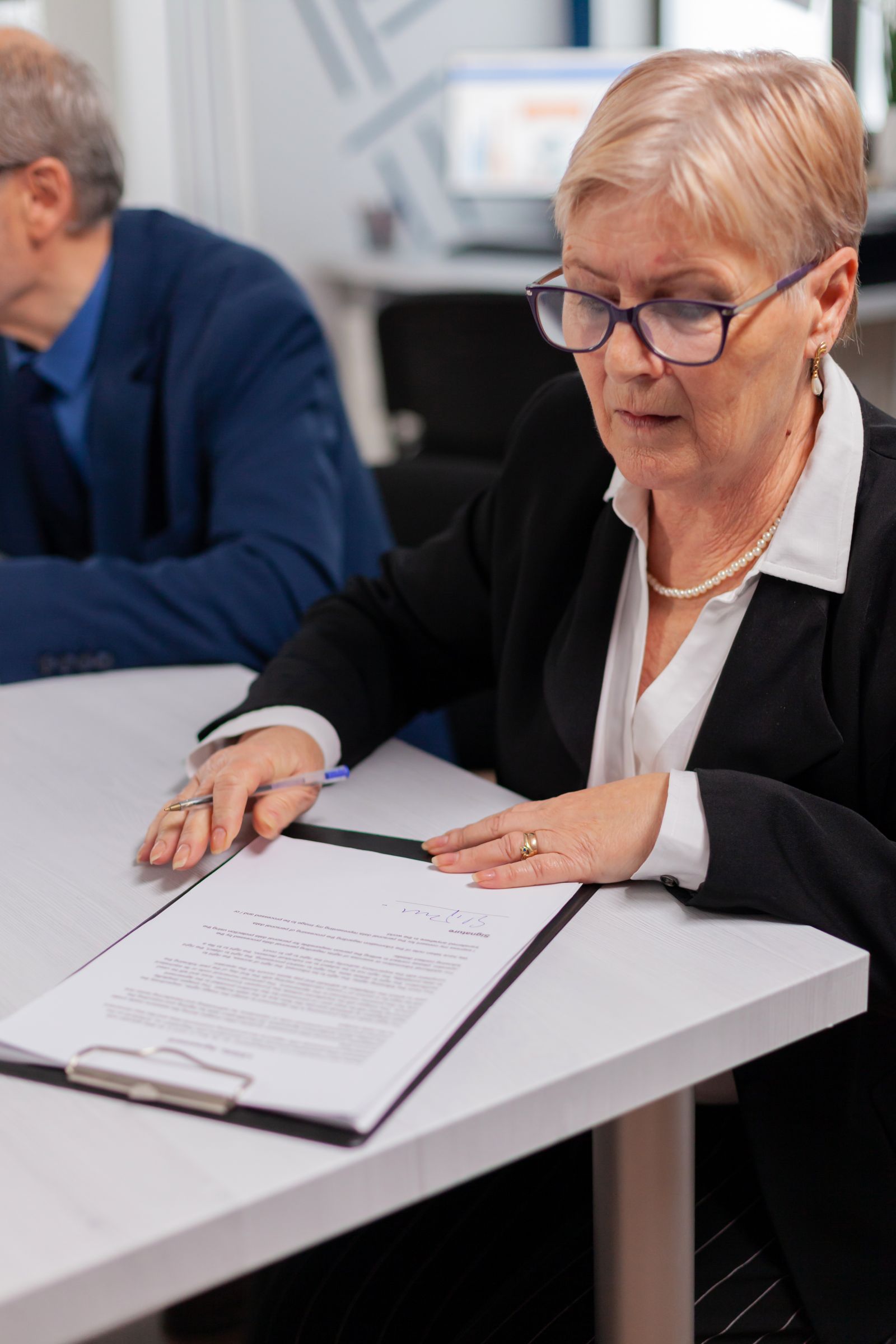 Woman Reading Financial Documents Conference Room Before Signing It